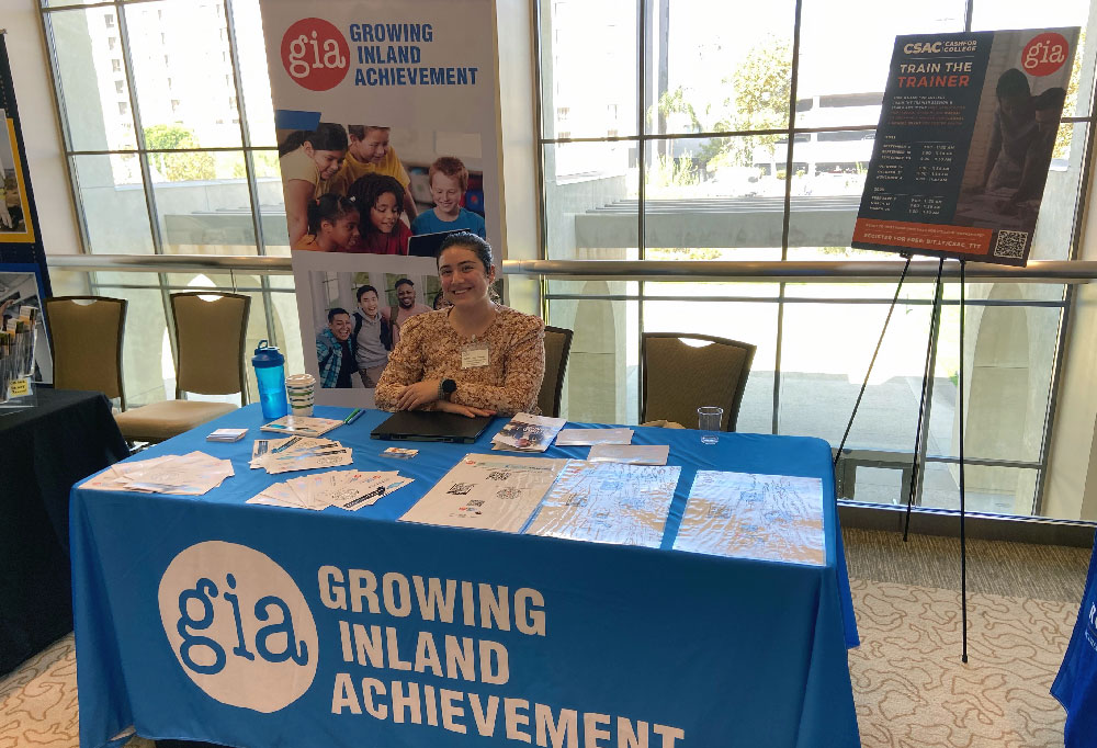 GIA employee Julissa Loza Mendez sits at promotional booth